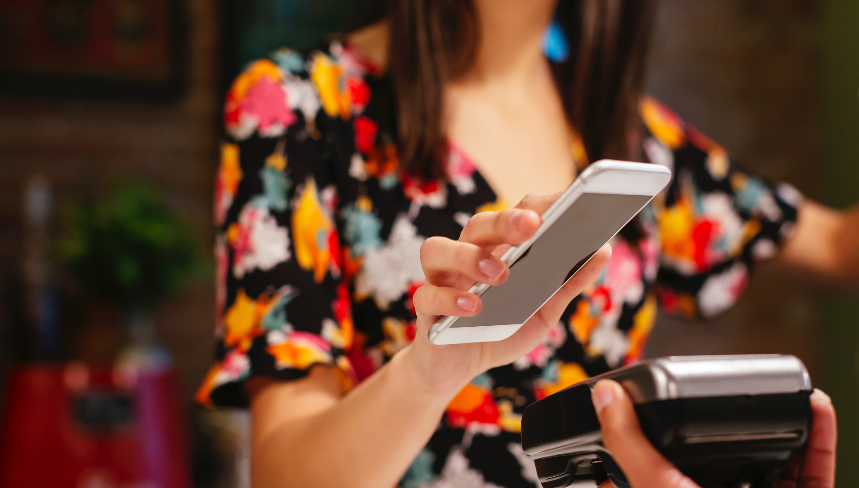 Woman paying with her phone