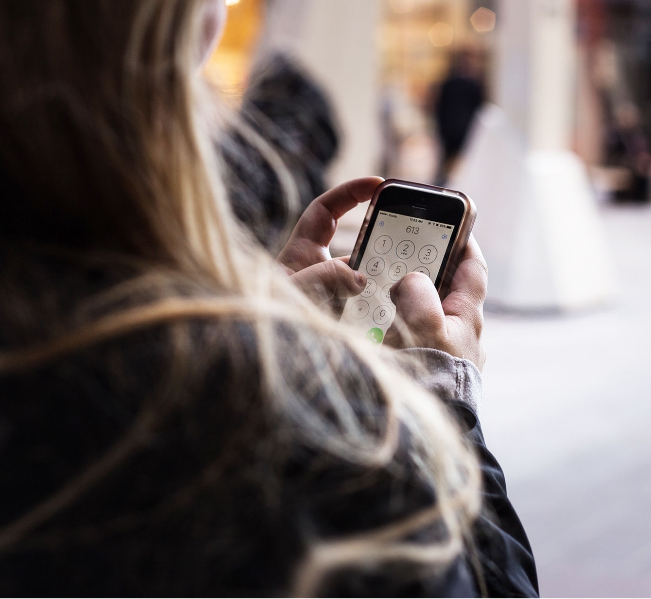 Woman logs into her mobile phone