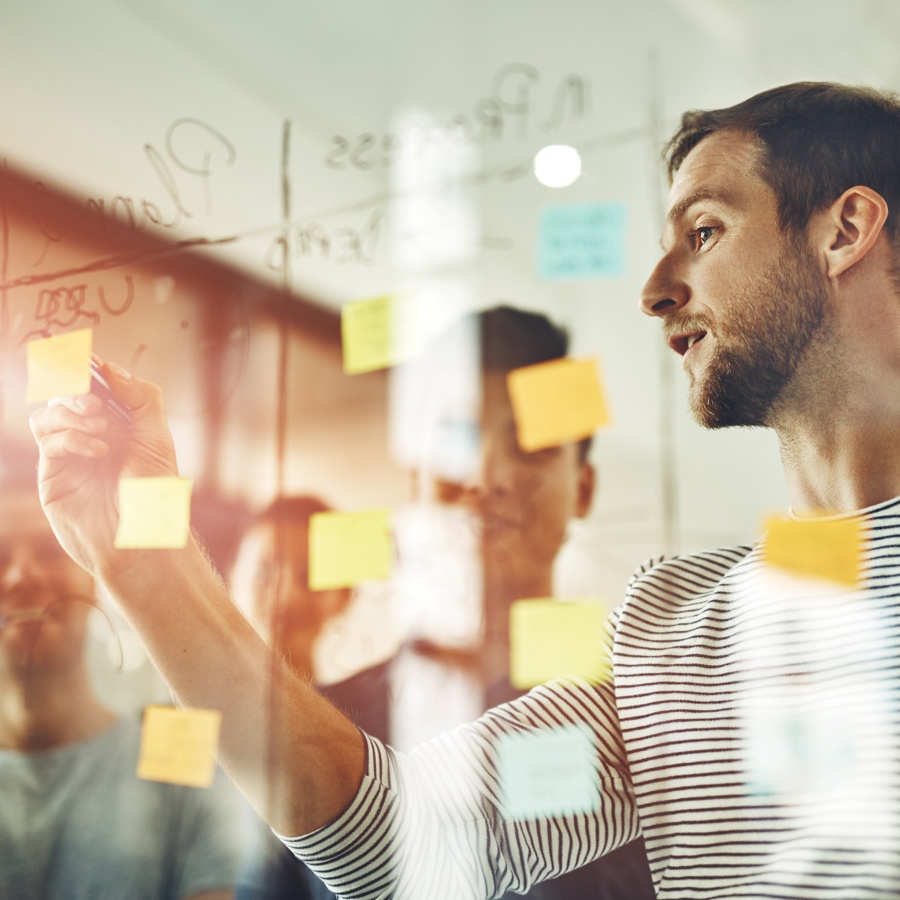 Person writing on a dry-erase board